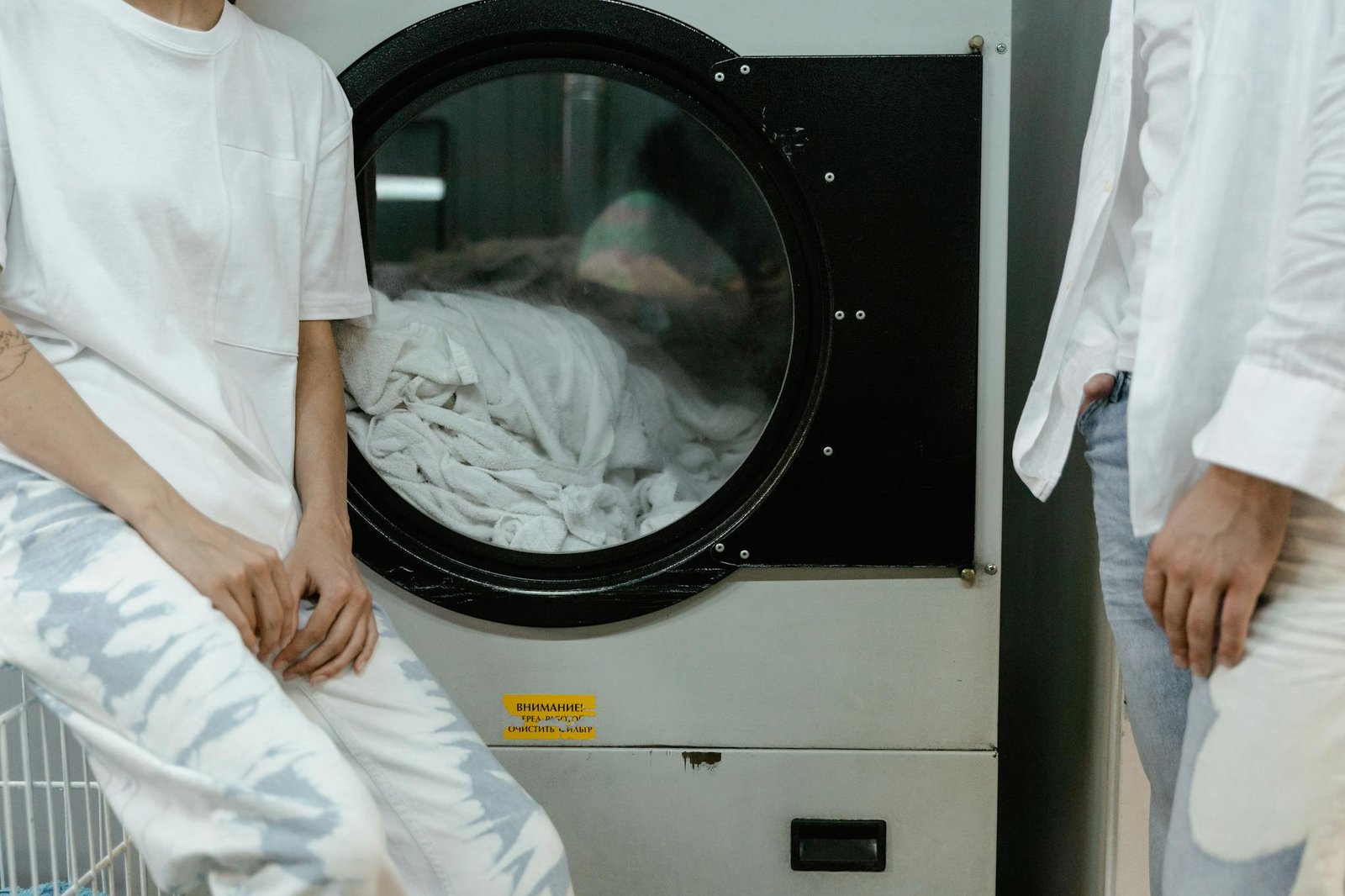 adults in white clothes using a washing