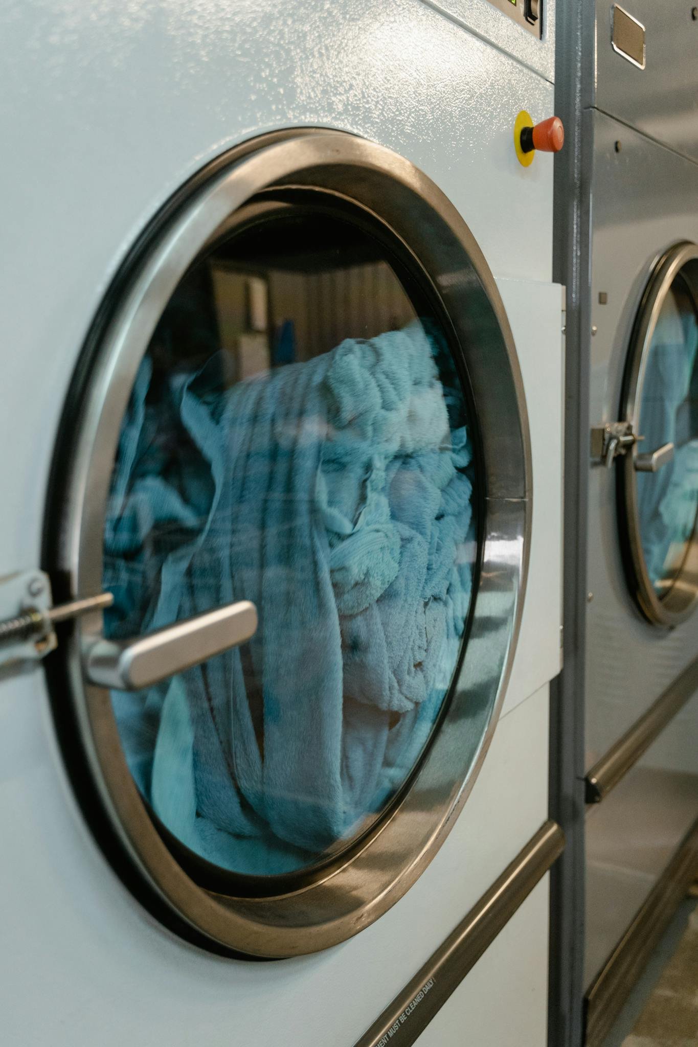 close up of an industrial laundry machine with